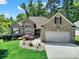 Charming brick home with a manicured lawn, stone accents, and a two-car garage at 1589 Essex Hall Dr, Rock Hill, SC 29730