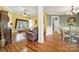 Open-concept living space with hardwood floors, a dining area, and a comfortable seating area at 1589 Essex Hall Dr, Rock Hill, SC 29730