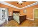 Spacious main bedroom with hardwood floors, bedside tables, natural lighting from windows, and light paint at 1589 Essex Hall Dr, Rock Hill, SC 29730