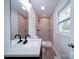 Updated bathroom with a single sink vanity, framed mirror and tiled shower at 163 Briarcliff Dr, Kannapolis, NC 28081