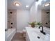 Bright bathroom with a bathtub and shower combo, tile walls, and modern fixtures at 163 Briarcliff Dr, Kannapolis, NC 28081
