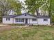 Charming single-story home with a freshly painted white brick exterior and well-maintained front yard at 163 Briarcliff Dr, Kannapolis, NC 28081