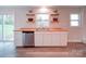 Kitchen sink area featuring stainless steel appliances, butcher block countertops, and floating shelves at 163 Briarcliff Dr, Kannapolis, NC 28081