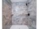 Walk in shower with stone-look tile, built in shelves, and modern shower head at 163 Briarcliff Dr, Kannapolis, NC 28081