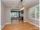 Elegant dining room featuring hardwood floors with open arch to living room and bright windows at 1720 Chatham Ave, Charlotte, NC 28205