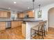 Open kitchen with breakfast bar, wooden stools, stainless steel appliances, and ample cabinet space at 1720 Chatham Ave, Charlotte, NC 28205