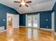 Main bedroom with hardwood floors, ceiling fan, and access to a private balcony at 1720 Chatham Ave, Charlotte, NC 28205