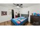 Cozy bedroom featuring a ceiling fan, dark wood floors, and a comfortable bed at 173 8Th Ave, Conover, NC 28613