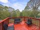 Outdoor deck with multiple chairs, a bench and views of the surrounding trees at 173 8Th Ave, Conover, NC 28613