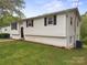 Exterior view of the home featuring a well-maintained lawn and mature trees at 173 8Th Ave, Conover, NC 28613