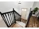 A well-lit staircase with a dark wood railing and hardwood floors at 173 8Th Ave, Conover, NC 28613