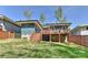 Backyard view showcases the home's deck and the large, well-maintained grassy area, great for outdoor activities at 1900 Lakedell Dr, Charlotte, NC 28215