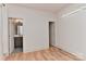 Spacious bedroom with light wood floors, ensuite bathroom, and bright, neutral walls at 1900 Lakedell Dr, Charlotte, NC 28215