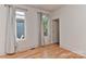 Cozy bedroom featuring two windows and bright hardwood flooring at 1900 Lakedell Dr, Charlotte, NC 28215