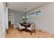 A modern dining room features wallpaper, a table with chairs, and clerestory windows providing natural light at 1900 Lakedell Dr, Charlotte, NC 28215