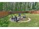 The backyard firepit area has four Adirondack chairs creating the perfect place for entertaining or relaxation at 1900 Lakedell Dr, Charlotte, NC 28215