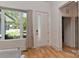 Bright foyer features wood floors, a window, and a white front door at 1900 Lakedell Dr, Charlotte, NC 28215