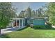 Inviting turquoise home features a well-manicured lawn and a covered carport at 1900 Lakedell Dr, Charlotte, NC 28215