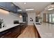A modern kitchen with dark cabinets, white countertops, and stainless-steel appliances at 1900 Lakedell Dr, Charlotte, NC 28215