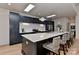 Bright kitchen featuring a large island with seating, dark cabinets, and skylights at 1900 Lakedell Dr, Charlotte, NC 28215