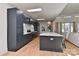 A modern kitchen is shown with custom cabinets, a large island, stainless steel appliances, and hardwood floors at 1900 Lakedell Dr, Charlotte, NC 28215
