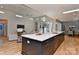 A modern living room features a large kitchen island with a sink and stainless steel appliances adjacent to a living area at 1900 Lakedell Dr, Charlotte, NC 28215