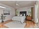 A relaxing main bedroom features hardwood floors, a ceiling fan, and natural light from surrounding windows at 1900 Lakedell Dr, Charlotte, NC 28215