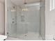 A modern glass-enclosed shower has tile walls, built-in shelving, and a rain shower head at 1900 Lakedell Dr, Charlotte, NC 28215