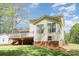 Exterior back of house with wooden deck, vinyl siding, and a well-maintained yard at 201 Olde Coach Ln, Crouse, NC 28033