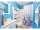 Bright bathroom features blue walls, a white vanity, toilet, and a shower-tub combination at 201 Olde Coach Ln, Crouse, NC 28033