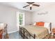 Comfortable bedroom with a metal frame bed, ceiling fan, and natural light from a single window at 201 Olde Coach Ln, Crouse, NC 28033