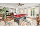Open-concept game room with pool table and natural light, connecting to dining area at 201 Olde Coach Ln, Crouse, NC 28033