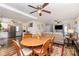 Inviting living room and dining area with ceiling fans, hardwood floors, and an open layout at 201 Olde Coach Ln, Crouse, NC 28033