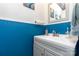 Stylish powder room with blue wainscoting, a modern vanity, and decorative nautical themed art at 201 Olde Coach Ln, Crouse, NC 28033