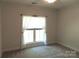 Bright bedroom with neutral walls and carpets; window with white curtains allowing in natural light at 2127 Cedar Rd, York, SC 29745