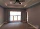 Spacious bedroom with neutral walls and carpets; window allowing in natural light at 2127 Cedar Rd, York, SC 29745