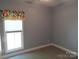Cozy bedroom featuring neutral paint, plush carpet, and window letting in natural light at 2127 Cedar Rd, York, SC 29745