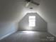 Spacious bedroom with neutral walls and carpets; window allowing in natural light at 2127 Cedar Rd, York, SC 29745