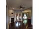 Bright living room with dark wood floors, a cozy fireplace, and access to dining area at 2127 Cedar Rd, York, SC 29745