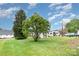 Expansive backyard with a trailer and parked truck under a bright, partly cloudy sky at 2218 W Fifth Ave, Gastonia, NC 28052