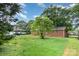 Exterior view showing brick home and yard with mature trees at 2218 W Fifth Ave, Gastonia, NC 28052