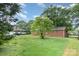 Backyard featuring a brick home, a tree, and a grassy lawn at 2218 W Fifth Ave, Gastonia, NC 28052