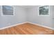 Bright bedroom featuring hardwood floors, neutral walls, and two windows at 2218 W Fifth Ave, Gastonia, NC 28052