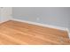 Bedroom featuring hardwood floors, neutral walls, and white baseboard trim at 2218 W Fifth Ave, Gastonia, NC 28052