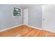 Bedroom featuring hardwood floors, light gray walls, window and closet at 2218 W Fifth Ave, Gastonia, NC 28052