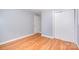 Bright bedroom features hardwood floors, closet with sliding doors and neutral wall color at 2218 W Fifth Ave, Gastonia, NC 28052