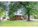Charming brick home with a well-maintained yard and beautiful mature tree at 2218 W Fifth Ave, Gastonia, NC 28052