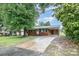 Beautiful one-story brick home with a large driveway and inviting covered carport at 2218 W Fifth Ave, Gastonia, NC 28052