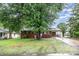 Charming one-story brick home featuring a well-maintained yard and mature shade tree at 2218 W Fifth Ave, Gastonia, NC 28052