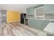 Open kitchen features modern appliances, sleek countertops, and gray wood-look floors at 2218 W Fifth Ave, Gastonia, NC 28052